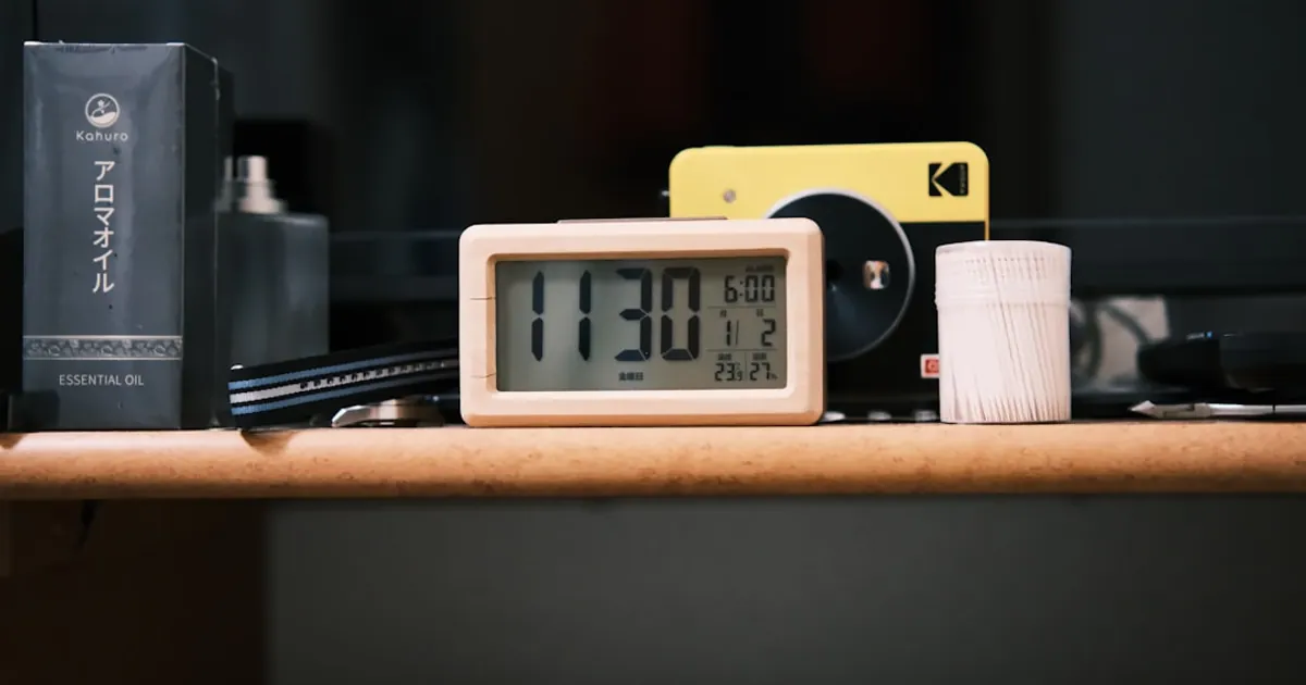 Digital clock shows 11:30 am with items on shelf. Digital clock shows 11:30 am with items on shelf.