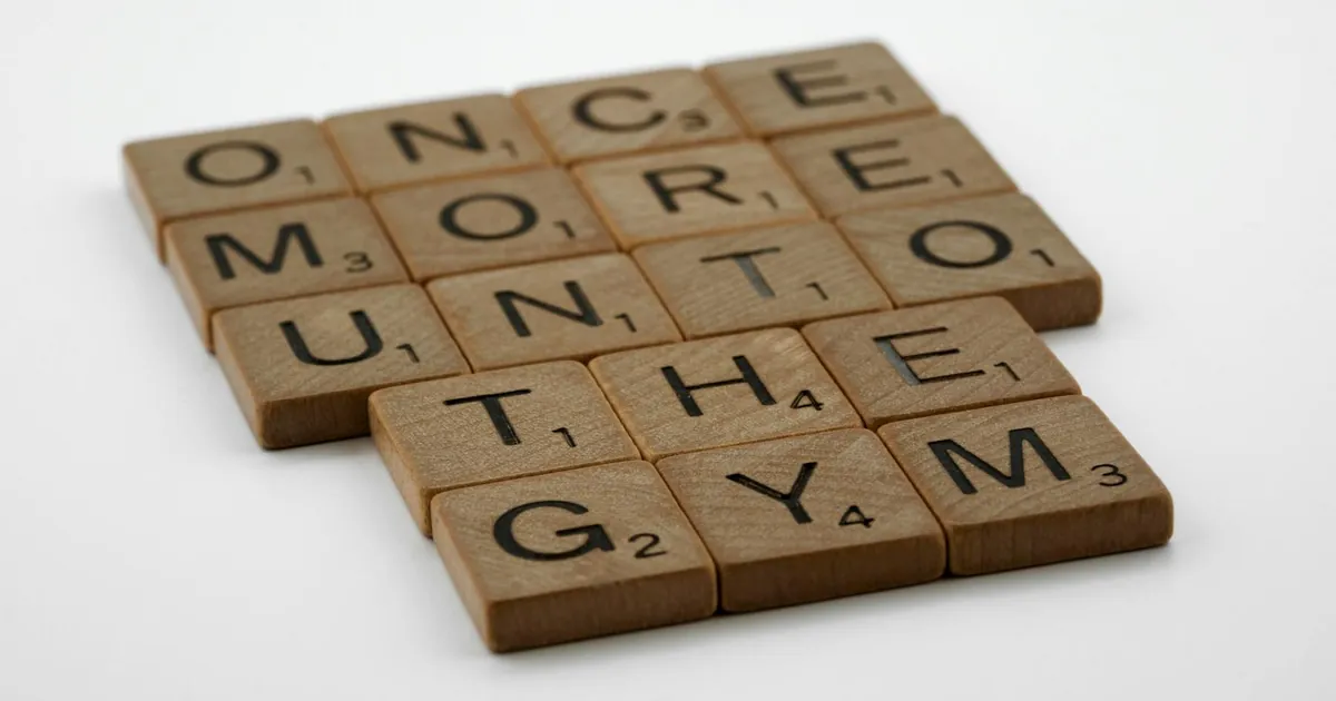Scrabble tiles forming the motivational phrase 'Once More Unto the Gym' on a white background.