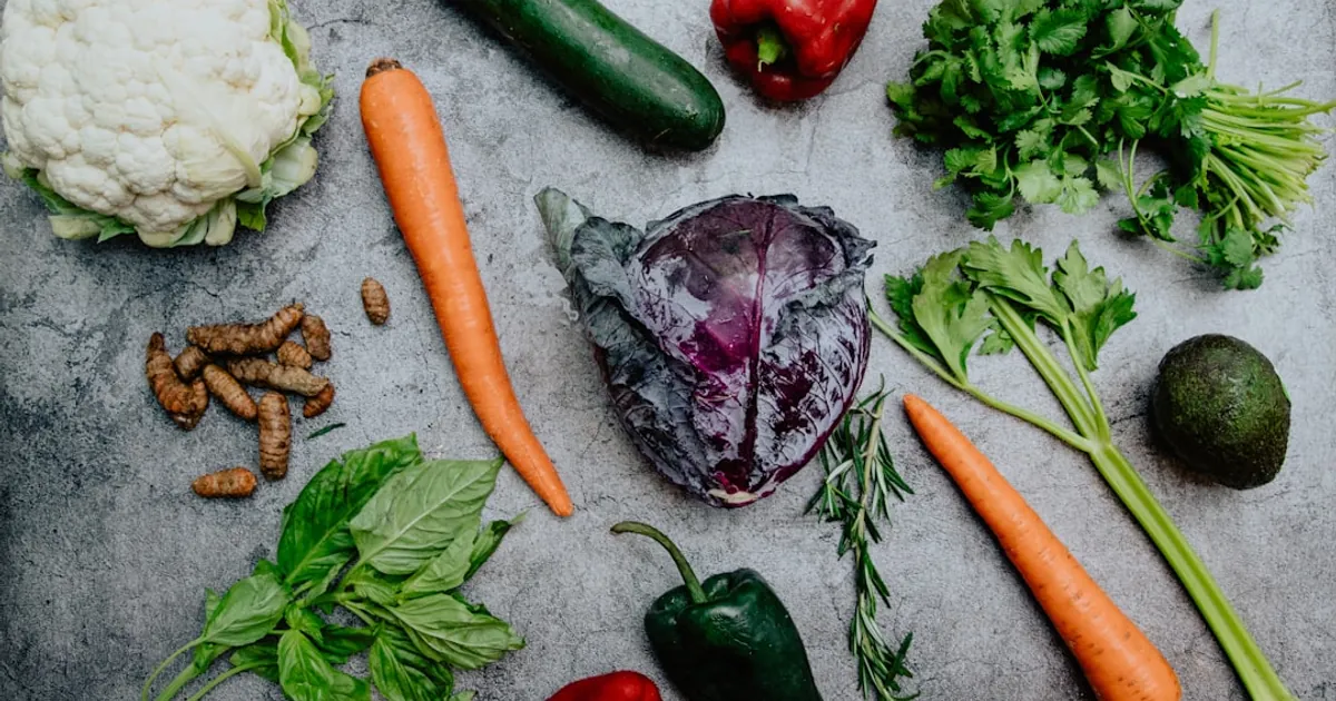 carrots and green vegetable on the ground