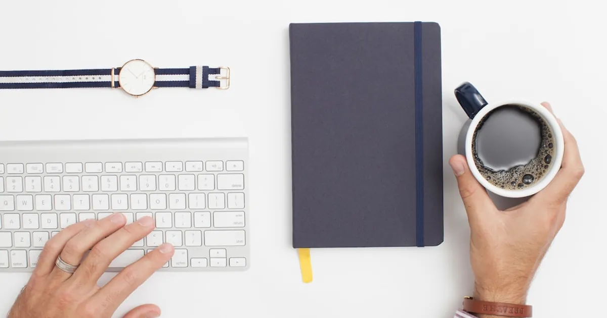 person holding black mug filled with black liquid person holding black mug filled with black liquid