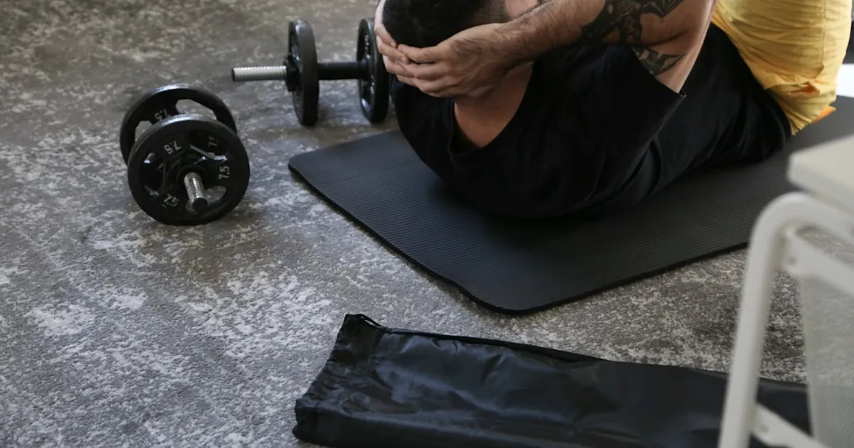 a man is doing exercises on a mat with a barbell a man is doing exercises on a mat with a barbell