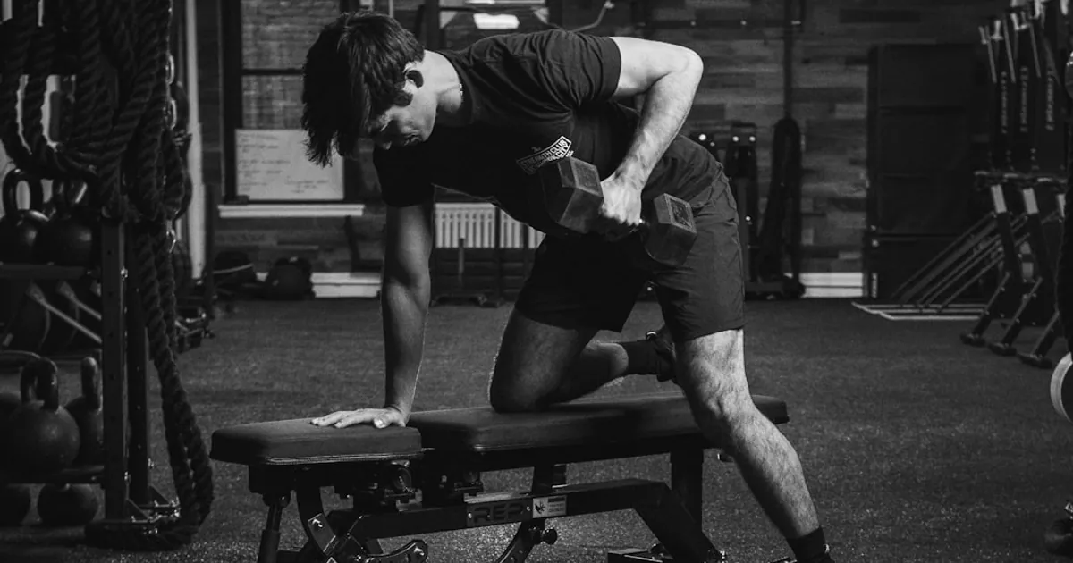 a man doing a bench press in a gym a man doing a bench press in a gym