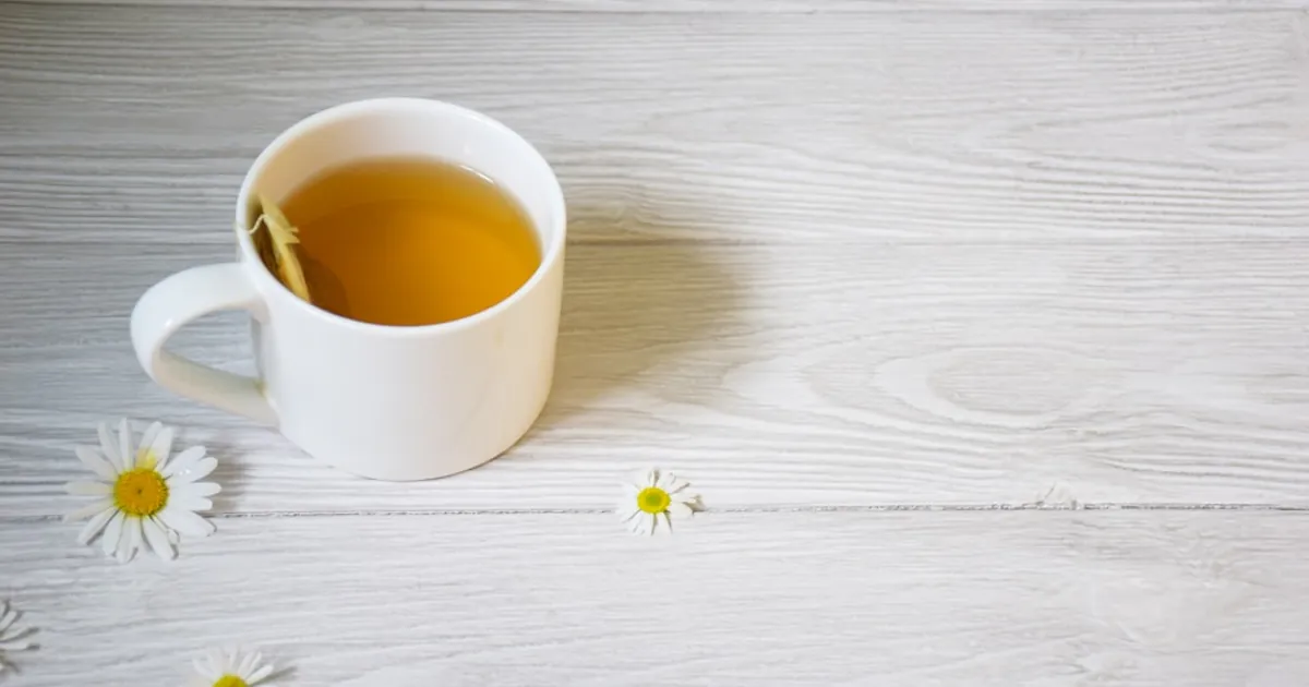 a cup of tea sitting on top of a white table