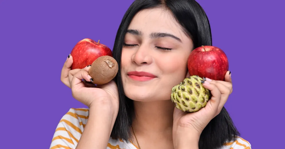 a woman holding apples and a frog a woman holding apples and a frog